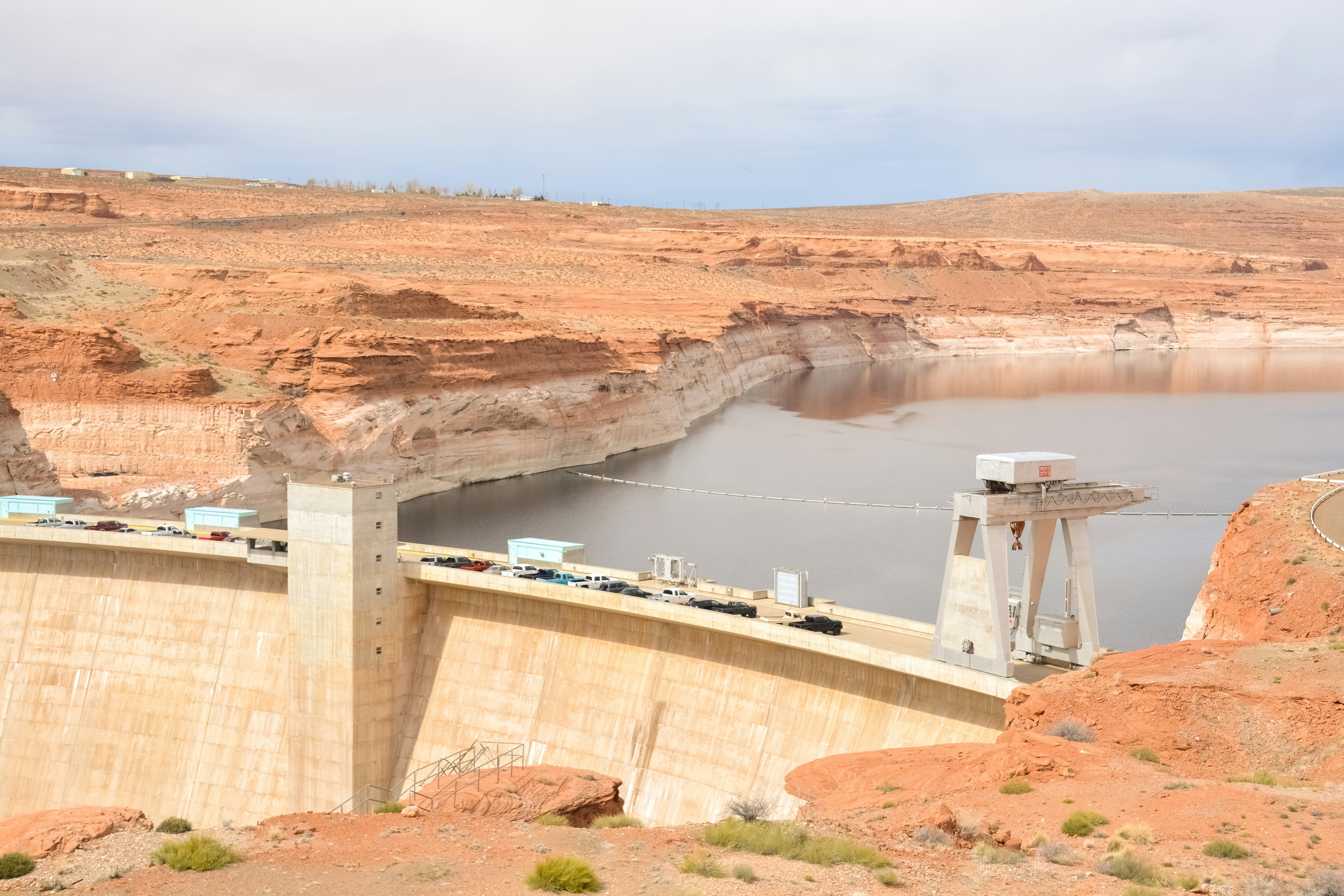 white water dam near brown mountain during daytime